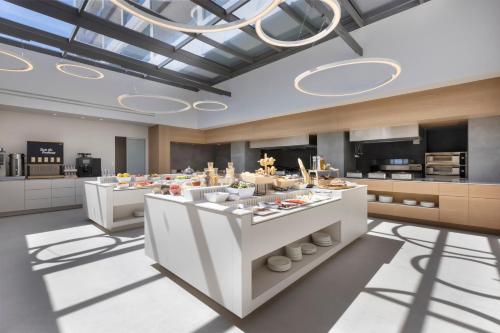 a large kitchen with a large island with food at Mirage Chalkida City Resort in Chalkida