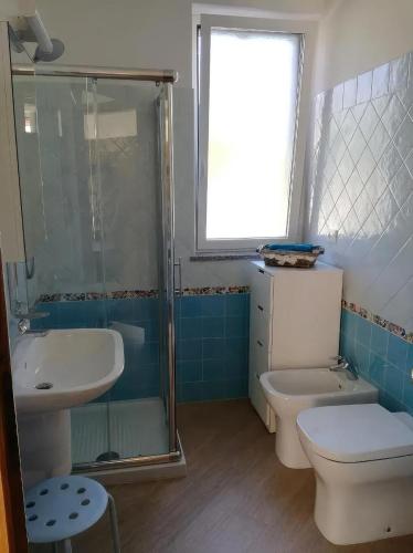 a bathroom with a toilet and a sink and a shower at Bed & Breakfast Ca' di Camineve in Loano