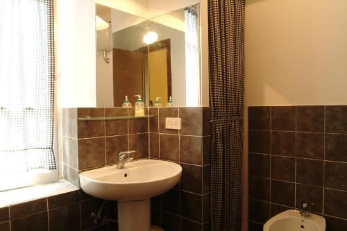 a bathroom with a sink and a mirror at Vacanze Romane 2 in Rome