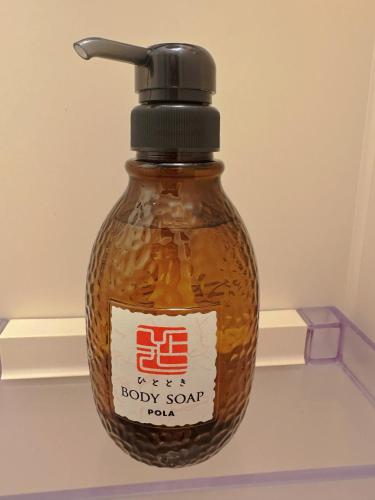 a bottle of baby soy sauce sitting on a shelf at Osaka Castle Park Station, 10 minutes walk to Kyobashi Station, direct access to Shinsaibashi, Umeda, Kansai Airport, Kyoto, Nara, USJ, can accommodate up to 10 people in Wada