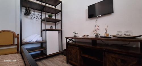 a room with a desk with a television on a wall at Conac Bistreanu in Eforie Sud