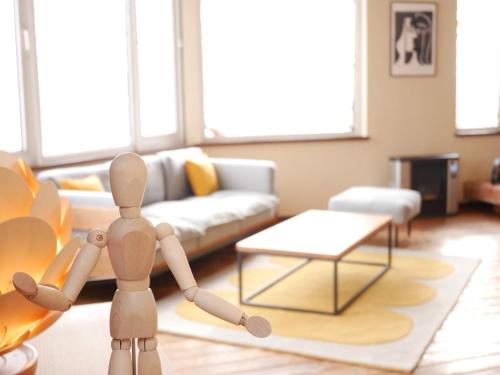 a wooden doll standing in a living room at Wonder Lodge Niseko in Niseko