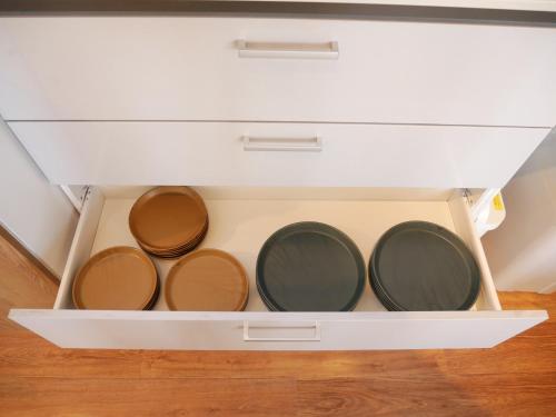 a white drawer filled with pots and pans at Wonder Lodge Niseko in Niseko