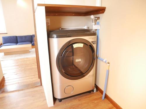 a washer and dryer in a small room at Wonder Lodge Niseko in Niseko