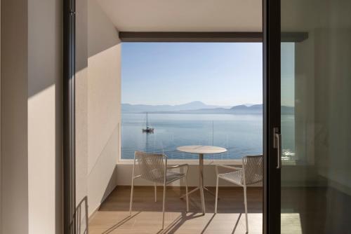 a view from the balcony of a house with a table and chairs at Mirage Chalkida City Resort in Chalkida