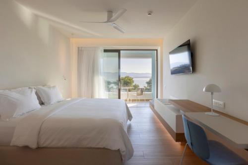 a hotel room with a bed and a large window at Mirage Chalkida City Resort in Chalkida