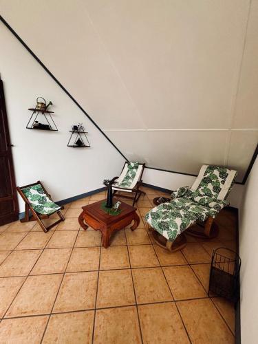 a living room with two chairs and a table at La Salazienne in Salazie