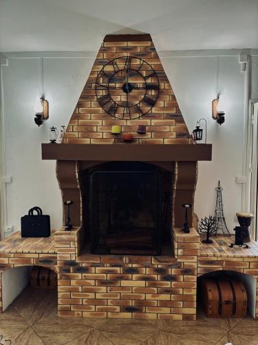 a brick fireplace with a clock on top of it at La Salazienne in Salazie