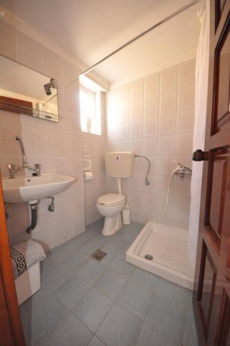 a bathroom with a toilet and a sink at Bikakis Family Apartments in Kissamos