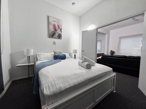 a bedroom with a large bed and a mirror at Spacious 4-Bedroom Home in Belgian Gardens in Belgian Gardens