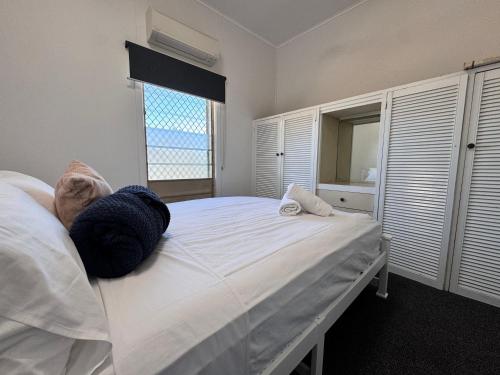 a bedroom with a large white bed with a window at Spacious 4-Bedroom Home in Belgian Gardens in Belgian Gardens