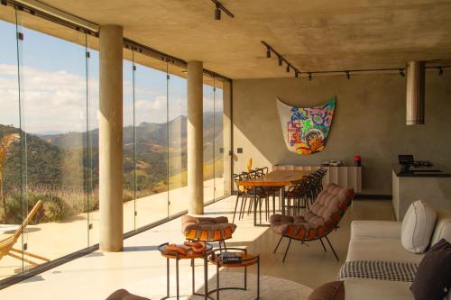 a living room with a view of the mountains at Windows House in Paty do Alferes