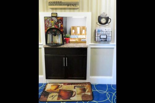 a doll house kitchen with a counter and a table at Rodeway Inn Logan International Airport in Revere