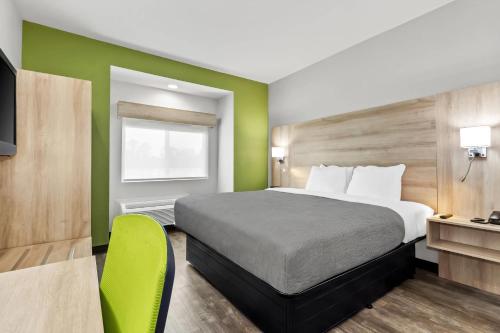 a hotel room with a bed and a window at Quality Inn Shallotte near Ocean Isle Beach in Shallotte