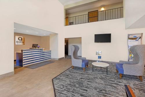a lobby with chairs and a table and a tv at Quality Inn Chesterton near Indiana Dunes National Park I-94 in Chesterton
