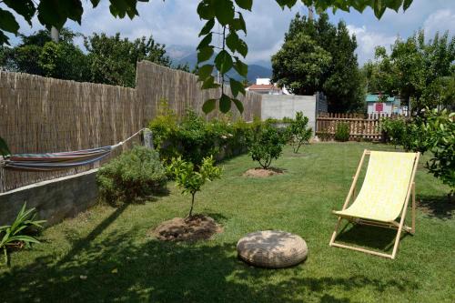 a chair sitting in a yard next to a fence at Bed & Breakfast Ca' di Camineve in Loano