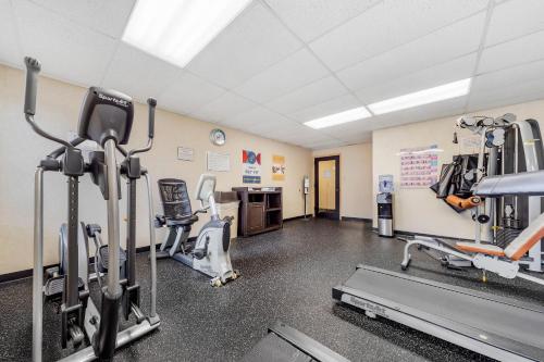 a gym with treadmills and machines in a room at Clarion Hotel & Conference Center in Toms River