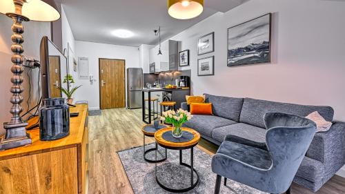 a living room with a couch and a table at Hillside, Sun & Snow in Karpacz