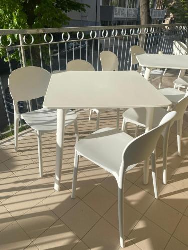 a white table and chairs on a patio at Hotel De La Ville in Rimini