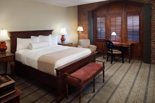 a hotel room with a bed and a desk at The Inn at Henderson's Wharf, an Ascend Collection Hotel in Baltimore