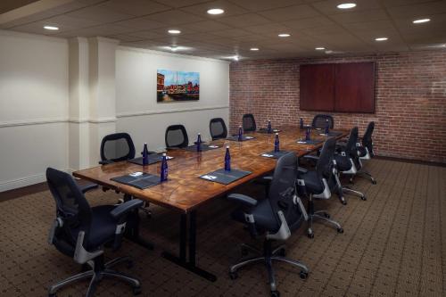 a conference room with a long table and chairs at The Inn at Henderson's Wharf, an Ascend Collection Hotel in Baltimore