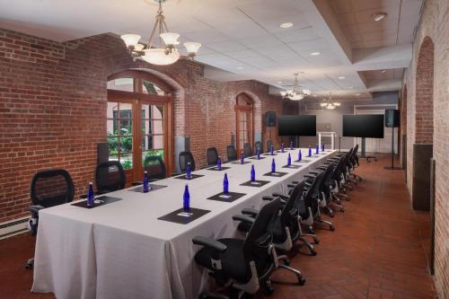 a conference room with a long table and chairs at The Inn at Henderson's Wharf, an Ascend Collection Hotel in Baltimore