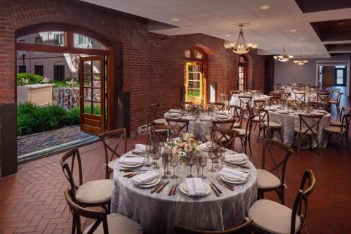 a dining room with tables and chairs in a building at The Inn at Henderson's Wharf, an Ascend Collection Hotel in Baltimore