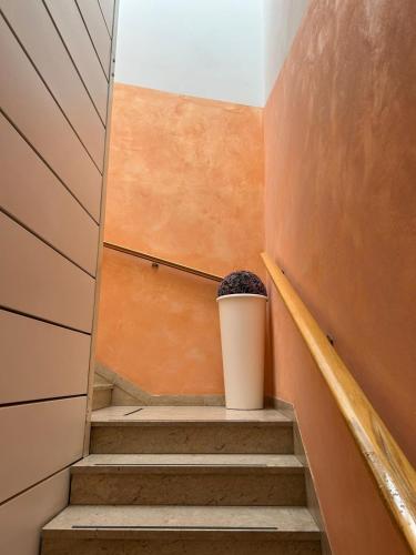 a stairway with a trash can sitting on top of it at Hotel De La Ville in Rimini