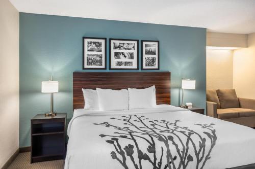 a hotel room with a bed and a chair at Sleep Inn near Penn State - State College, PA in State College