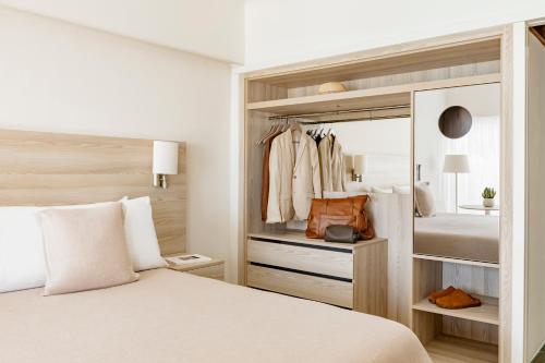 a bedroom with a bed and a closet at Paradisus Salinas Lanzarote - All Inclusive - Adults Only in Costa Teguise