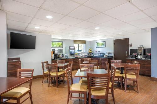 a restaurant with tables and chairs and a bar at Sleep Inn near Penn State - State College, PA in State College