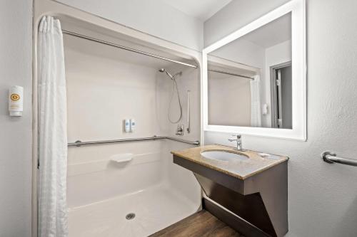 a white bathroom with a sink and a shower at Comfort Suites Columbia at Harbison in Columbia