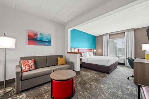a hotel room with a bed and a couch at Comfort Suites Columbia at Harbison in Columbia