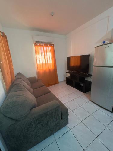 a living room with a couch and a refrigerator at Casa Texas in Ciudad Victoria