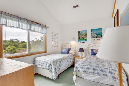 a bedroom with two beds and a window at PS-I -Swan Sea in Duck
