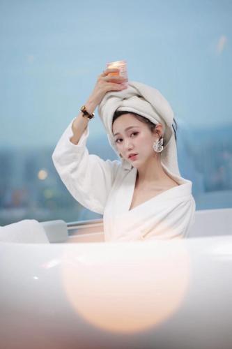 a woman with a towel on her head on a boat at Chongqing Jiayu Emperor Hotel in Jiulongpo