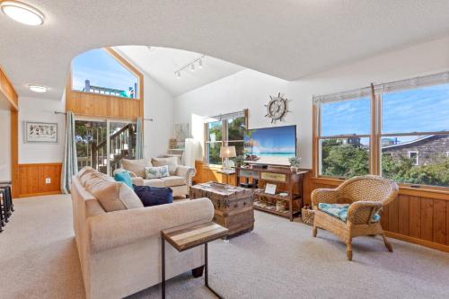 a living room with a couch and a tv at 8074 - Sea Glass Charmer in Avon