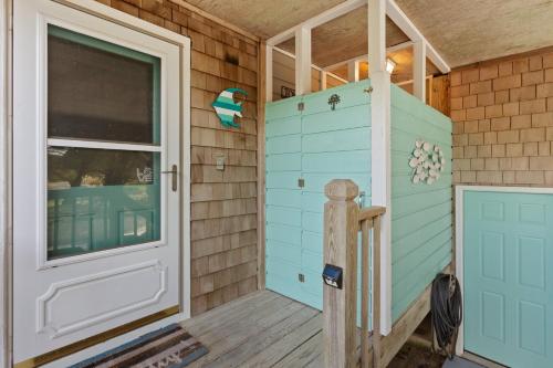 a door to the outside of a tiny house at 8074 - Sea Glass Charmer in Avon