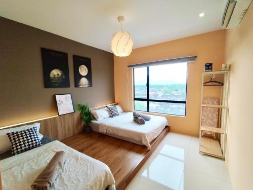 a bedroom with two beds and a large window at Ipoh Waterpark Manhattan Premium Suites by IWH Suites in Ipoh