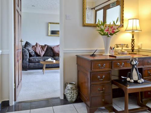 a living room with a dresser and a couch at Woodend Bungalow in Hucknall under Huthwaite