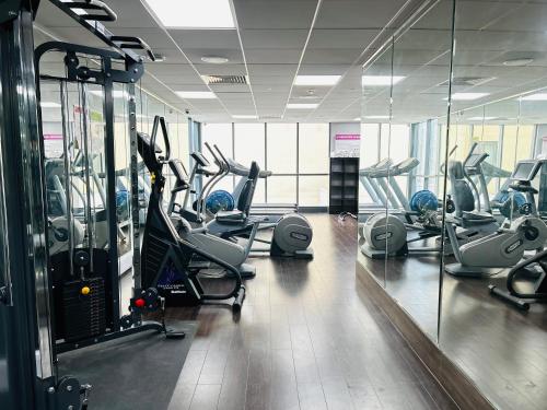 a gym with treadmills and ellipticals in a building at Crowne Plaza London - Kingston by IHG in Kingston upon Thames