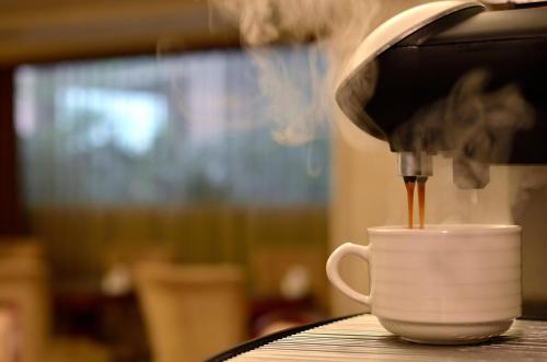a coffee maker is making a cup of coffee at Lake Hotel in Xindian