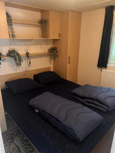 two beds sitting on top of a bed in a room at KD 743 - Vakantiepark Kijkduin in The Hague