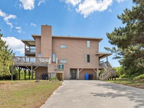 a large house with a wrap around porch and a driveway at 2030 - Horizon`s Summit in Duck