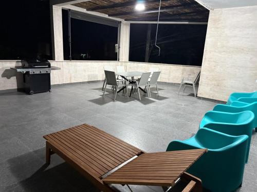 a patio with chairs and a table and a table and chairs at Villa Sunlight in Gonio