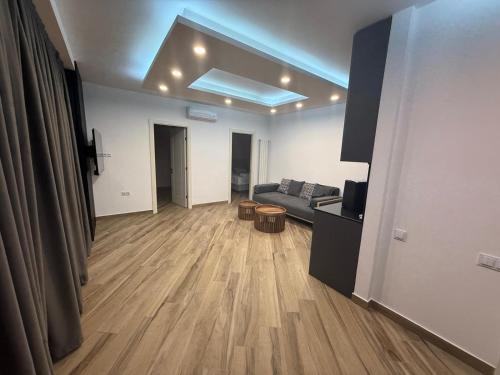 a living room with a couch and wooden floors at Villa Sunlight in Gonio