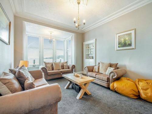 a living room with couches and a table at Argyle House in Rothesay