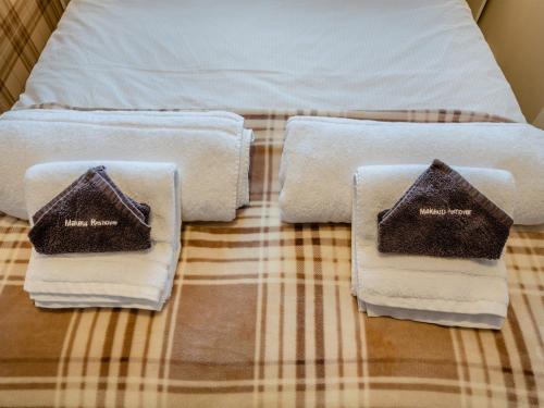 a bed with two towels on top of it at Argyle House in Rothesay