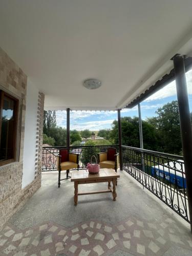 a patio with a table and chairs on a balcony at Agropensiune Lupu 