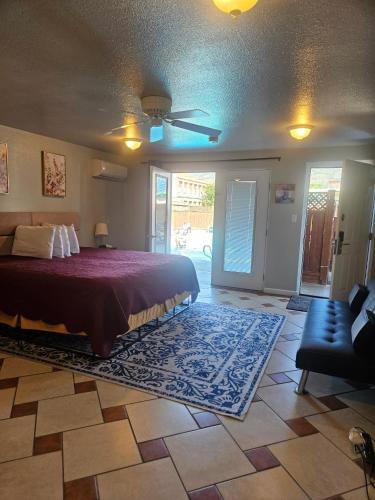 a bedroom with a bed and a living room at Camaray Motel in Oroville